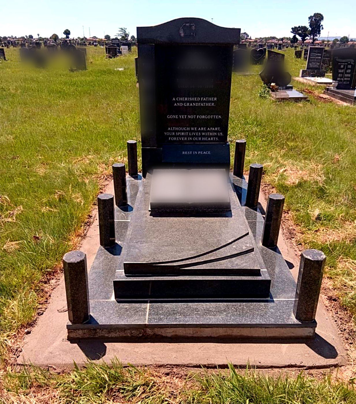 Full granite kerb set memorial with an open book and pillar posts